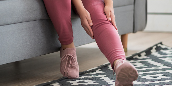 Woman massaging her legs